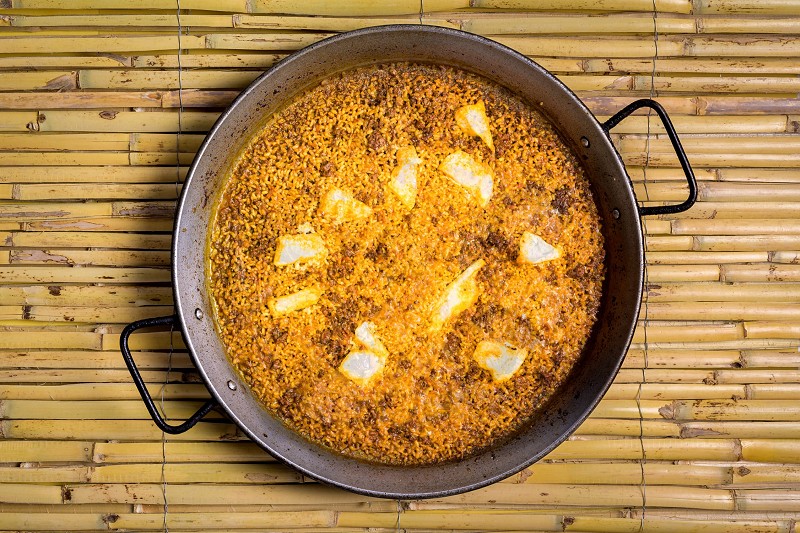 Paella with died pepper and cod